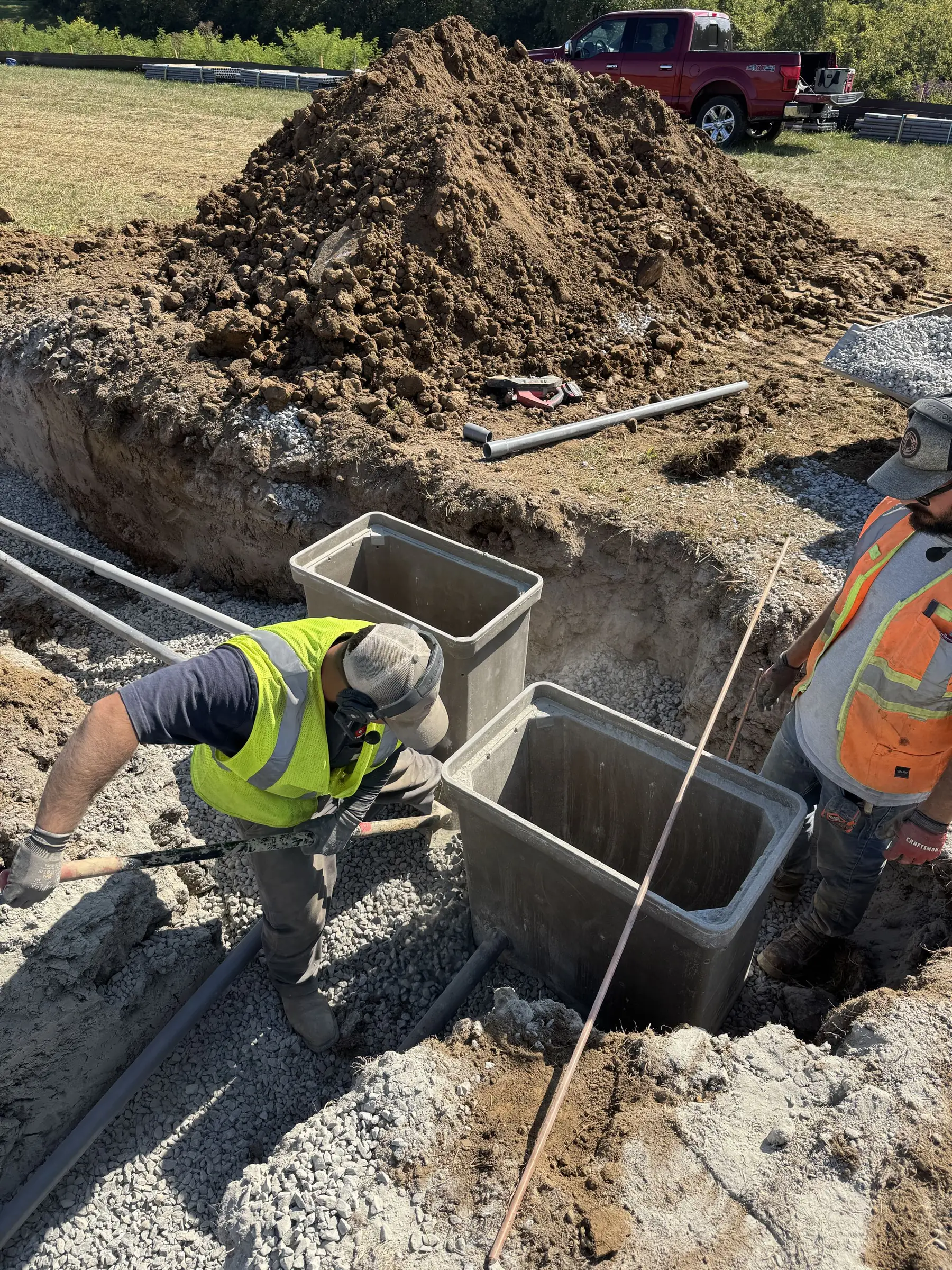Underground electrical conduit running through an open construction trench.